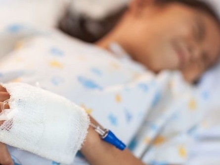 Girl in hospital gown with IV